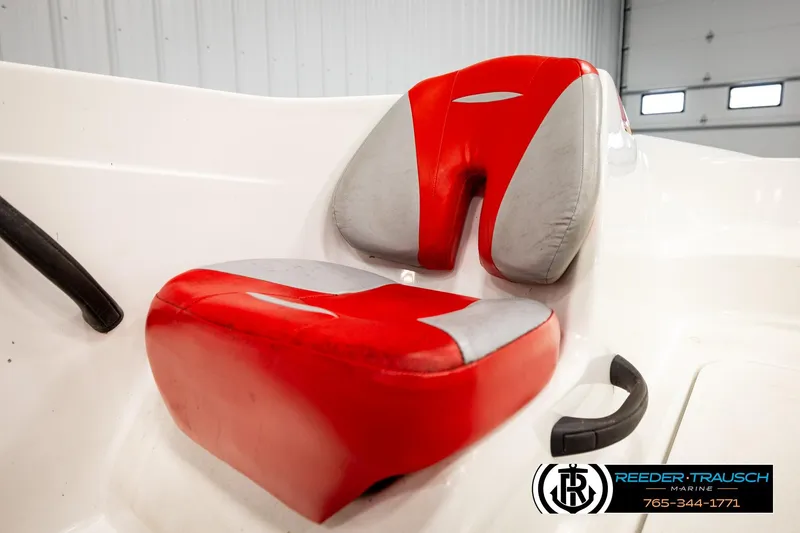 Slide: The Image of Red and gray seat of 2007 Sea Doo 150 Speedster boat in a garage setting. - 27