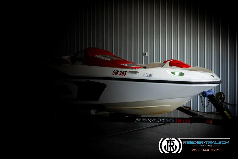 Slide: The Image of 2007 Sea Doo 150 Speedster boat in a dimly lit garage, side view. - 3