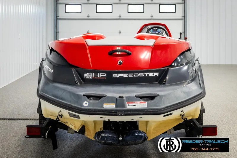 Slide: The Image of 2007 Sea Doo 150 Speedster, red and black, rear view in a garage setting. - 6