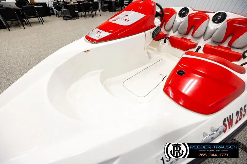 Slide: The Image of 2007 Sea Doo 150 Speedster boat interior with red and white seating in showroom. - 9