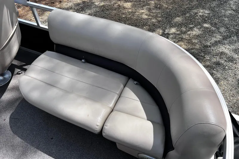 Slide: The Image of 2017 Sun Tracker Party Barge 22 DLX pontoon boat seating area, featuring comfortable beige upholstery. - 11