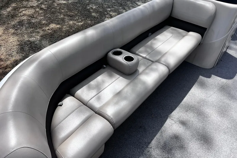 Slide: The Image of 2017 Sun Tracker Party Barge 22 DLX interior seating with cup holders, gray upholstery. - 17
