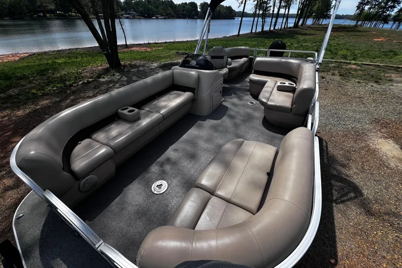 Slide: The Image of 2017 Sun Tracker Party Barge 22 DLX pontoon boat with spacious seating by a lake. - 20