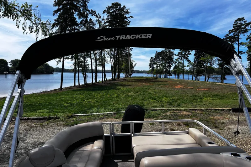 Slide: The Image of 2017 Sun Tracker Party Barge 22 DLX on a scenic lakeside view. - 4