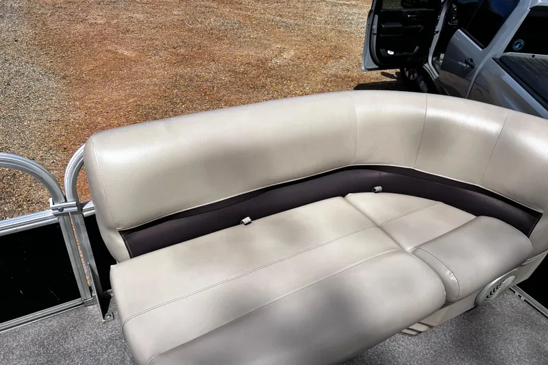 Slide: The Image of 2017 Sun Tracker Party Barge 22 DLX with beige seating and open truck door in background. - 6