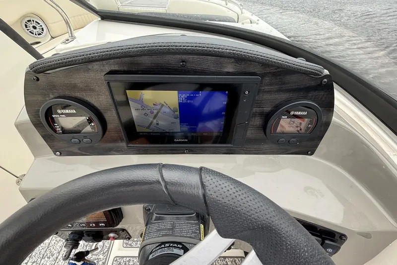 Slide: The Image of 2021 Stingray 231 DC boat interior with plush seating and textured flooring. - 11