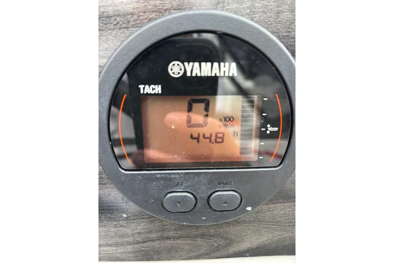 Slide: The Image of Steering wheel and dashboard of 2021 Stingray 231 DC boat on water. - 24