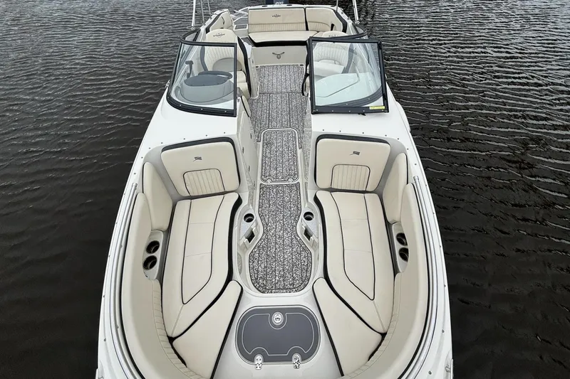 Slide: The Image of 2021 Stingray 231 DC boat interior with spacious seating and elegant design on water. - 5