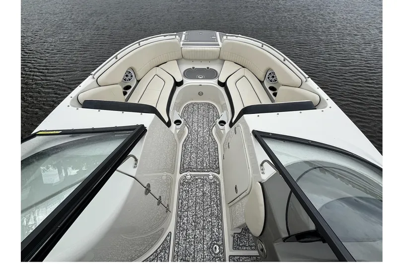 Slide: The Image of 2021 Stingray 231 DC boat interior with spacious seating on calm water. - 6