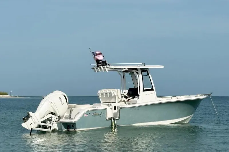 The Image of 2023 Sea Hunt Ultra 239 SE boat anchored in calm waters. - 0
