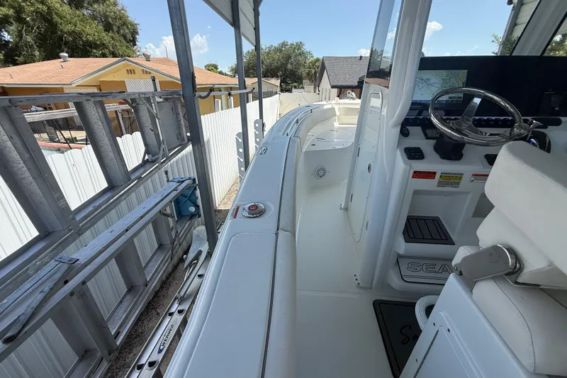 Slide: The Image of 2023 Sea Hunt Ultra 239 SE boat interior with steering wheel and control panel. - 15