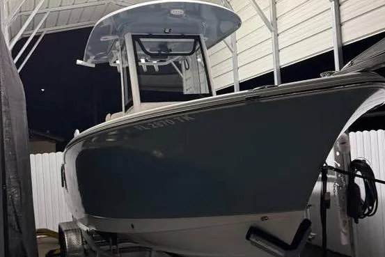 Slide: The Image of 2023 Sea Hunt Ultra 239 SE boat under a covered dock at night. - 10