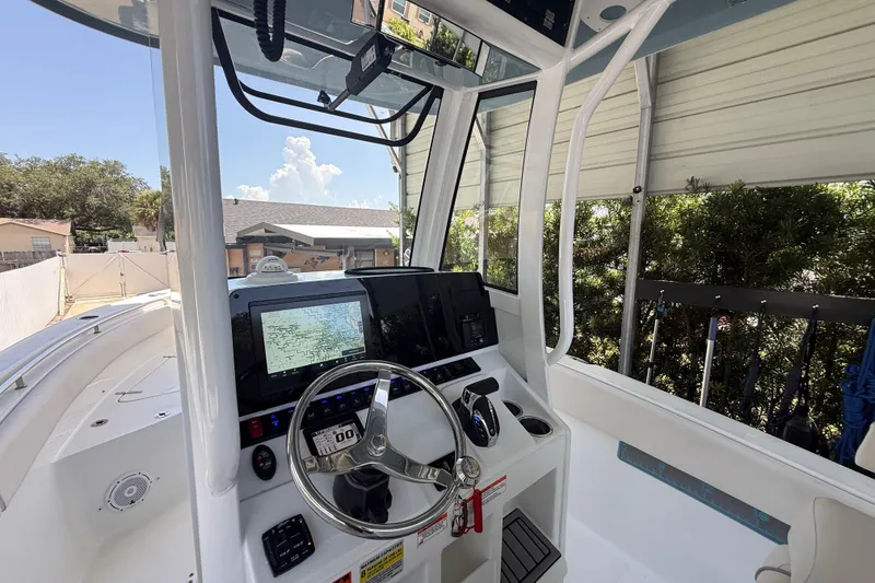 Slide: The Image of 2023 Sea Hunt Ultra 239 SE boat cockpit with modern navigation system and steering wheel. - 9