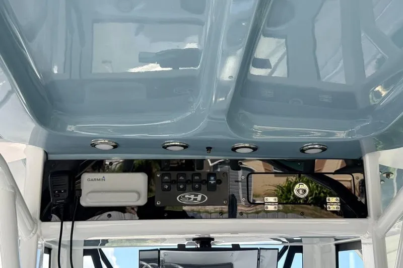 Slide: The Image of 2023 Sea Hunt Ultra 239 SE boat dashboard with Garmin electronics and control panel. - 13