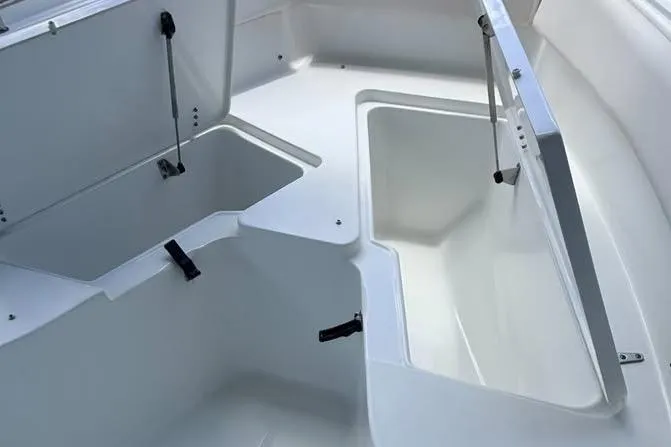 Slide: The Image of 2023 Sea Hunt Ultra 239 SE boat storage compartments open, showcasing spacious interior design. - 15
