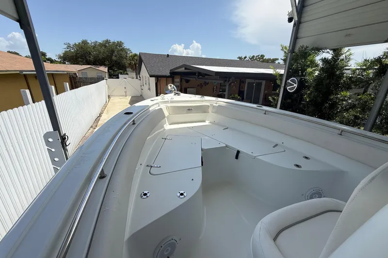 Slide: The Image of 2023 Sea Hunt Ultra 239 SE boat docked in a residential driveway. - 19