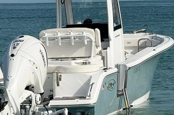 Slide: The Image of 2023 Sea Hunt Ultra 239 SE boat with Yamaha engine on calm water. - 16