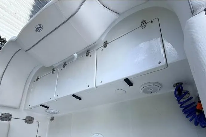 Slide: The Image of 2023 Sea Hunt Ultra 239 SE boat storage compartments and seating area. - 3