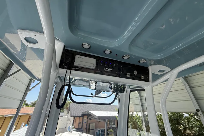 Slide: The Image of 2023 Sea Hunt Ultra 239 SE boat console with electronics and overhead storage. - 12
