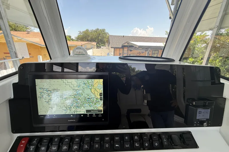 Slide: The Image of 2023 Sea Hunt Ultra 239 SE dashboard with Garmin navigation system and control panel. - 11