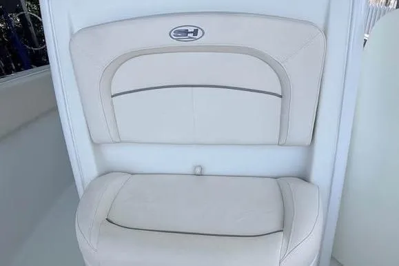 Slide: The Image of 2023 Sea Hunt Ultra 239 SE boat seat with logo, featuring white cushioned upholstery. - 9