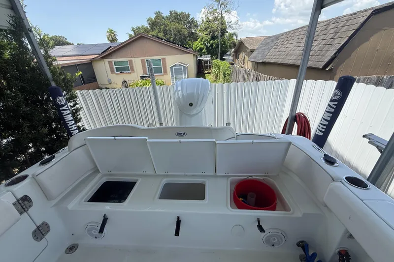 Slide: The Image of 2023 Sea Hunt Ultra 239 SE boat interior with storage compartments and Yamaha equipment. - 4