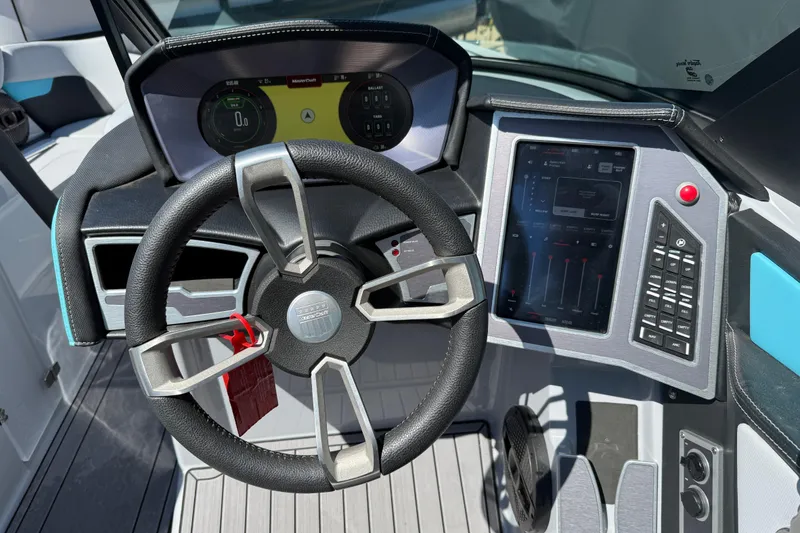 Slide: The Image of 2023 MasterCraft XT24 boat dashboard with steering wheel and digital controls. - 10
