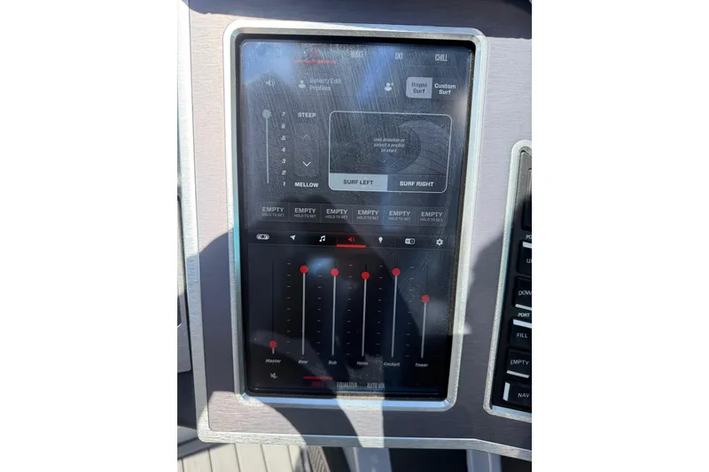Slide: The Image of 2023 MasterCraft XT24 control panel with touchscreen interface for surf settings. - 12