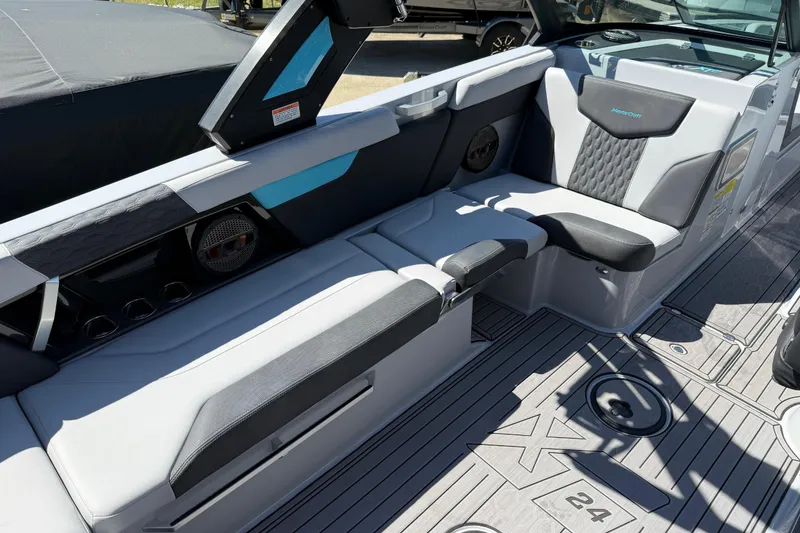 Slide: The Image of 2023 MasterCraft XT24 boat interior with sleek seating and modern design. - 16
