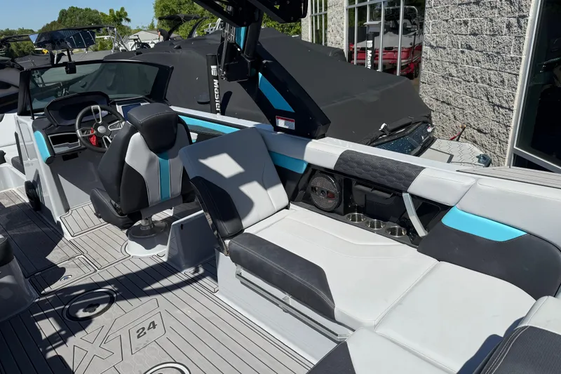 Slide: The Image of 2023 MasterCraft XT24 boat interior with modern seating and steering wheel. - 20