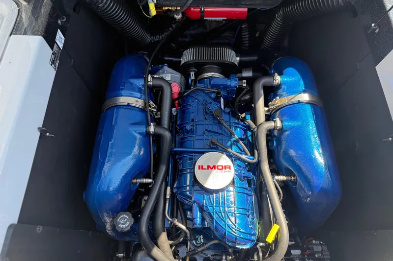 Slide: The Image of 2023 MasterCraft XT24 Ilmor engine with blue components and detailed piping. - 23