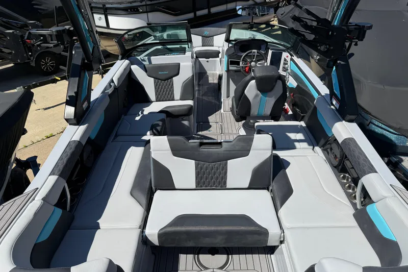 Slide: The Image of 2023 MasterCraft XT24 boat interior with modern seating and sleek design. - 25