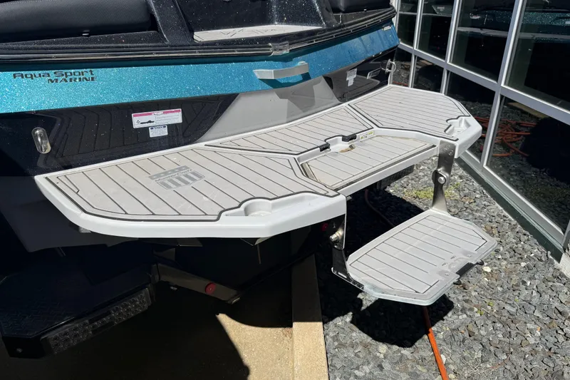Slide: The Image of 2023 MasterCraft XT24 boat swim platform with Aqua Sport Marine branding. - 28