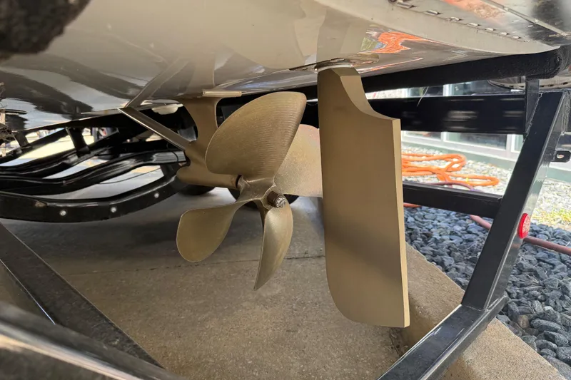 Slide: The Image of 2023 MasterCraft XT24 boat propeller and rudder detail on trailer. - 30