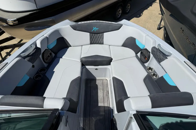 Slide: The Image of 2023 MasterCraft XT24 boat interior with spacious seating and modern design. - 5