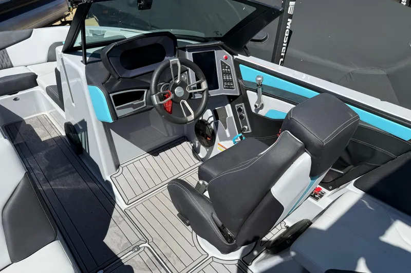 Slide: The Image of 2023 MasterCraft XT24 boat interior with modern steering and seating design. - 9