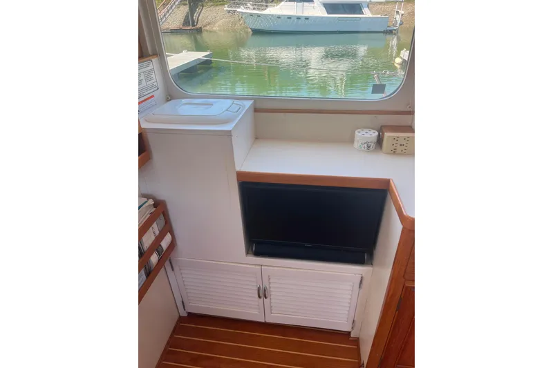 Slide: The Image of Interior of 1972 DeFever 38 Passagemaker with window view and storage cabinets. - 15