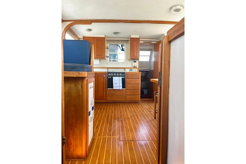 Slide: The Image of Interior of 1972 DeFever 38 Passagemaker with wooden cabinetry and flooring. - 16