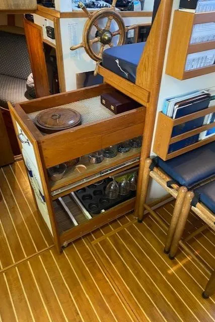 Slide: The Image of Interior of 1972 DeFever 38 Passagemaker with wooden flooring and storage shelves. - 19
