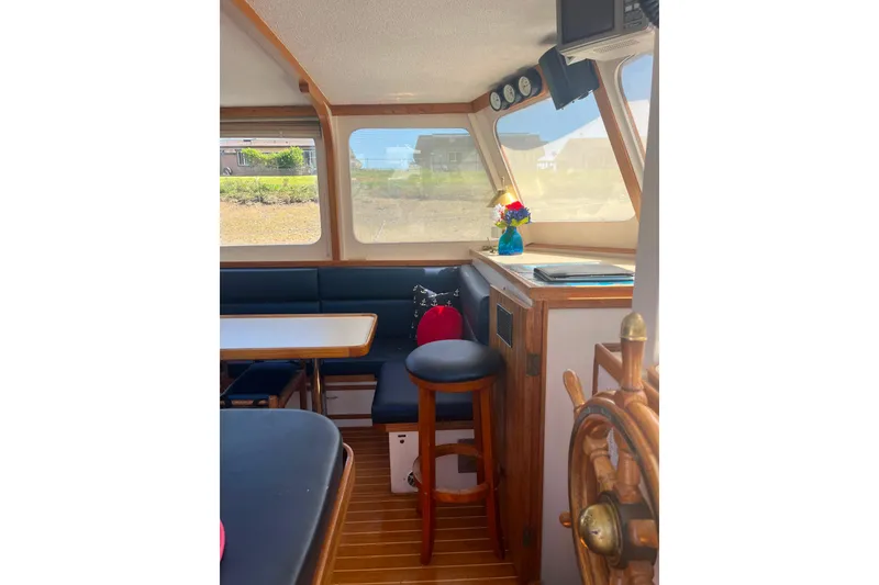 Slide: The Image of Interior of 1972 DeFever 38 Passagemaker with wooden helm, seating, and nautical decor. - 22