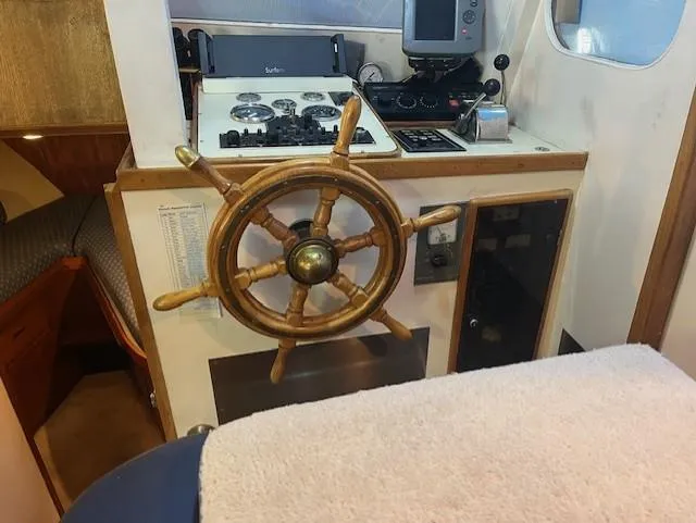 Slide: The Image of 1972 DeFever 38 Passagemaker helm with wooden wheel and navigation equipment. - 23