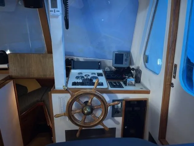 Slide: The Image of 1972 DeFever 38 Passagemaker helm with wooden wheel and navigation instruments. - 26