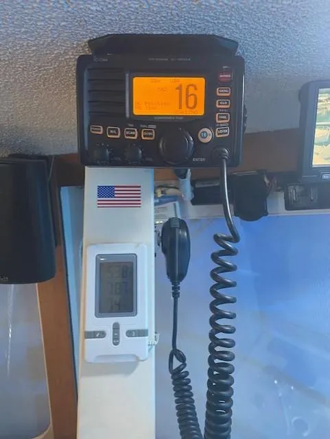 Slide: The Image of Radio equipment on a 1972 DeFever 38 Passagemaker boat, featuring a digital display and American flag. - 28