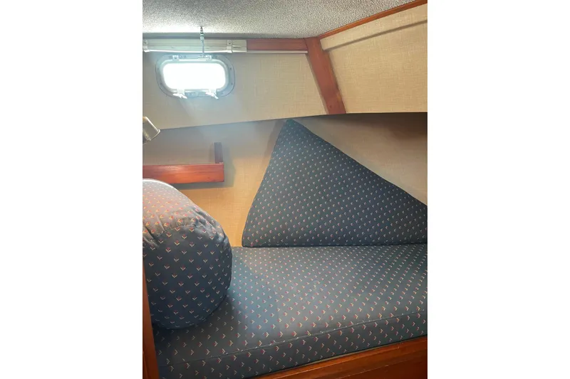 Slide: The Image of Cozy cabin interior of 1972 DeFever 38 Passagemaker with patterned cushions and porthole. - 40