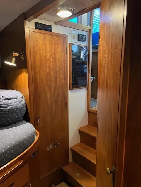 Slide: The Image of Interior of 1972 DeFever 38 Passagemaker with wooden cabinetry and stairs. - 43