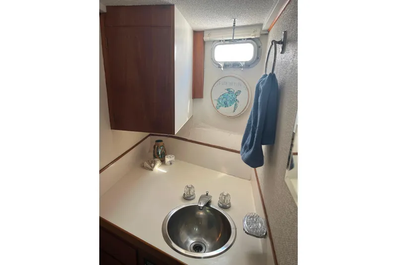Slide: The Image of 1972 DeFever 38 Passagemaker bathroom with sink, towel, and nautical decor. - 47