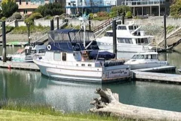 Slide: The Image of 1972 DeFever 38 Passagemaker yacht docked in a marina, surrounded by other boats. - 5