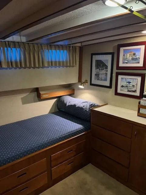 Slide: The Image of Cozy cabin interior of 1972 DeFever 38 Passagemaker with bed, wooden drawers, and framed artwork. - 52