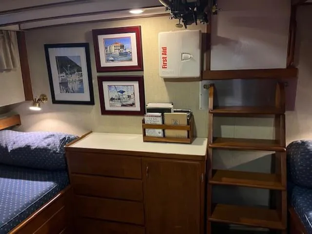 Slide: The Image of Interior of 1972 DeFever 38 Passagemaker with wooden cabinetry and nautical decor. - 53