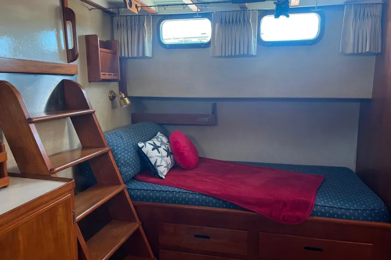 Slide: The Image of Cozy cabin interior of 1972 DeFever 38 Passagemaker with wooden shelves and nautical decor. - 54